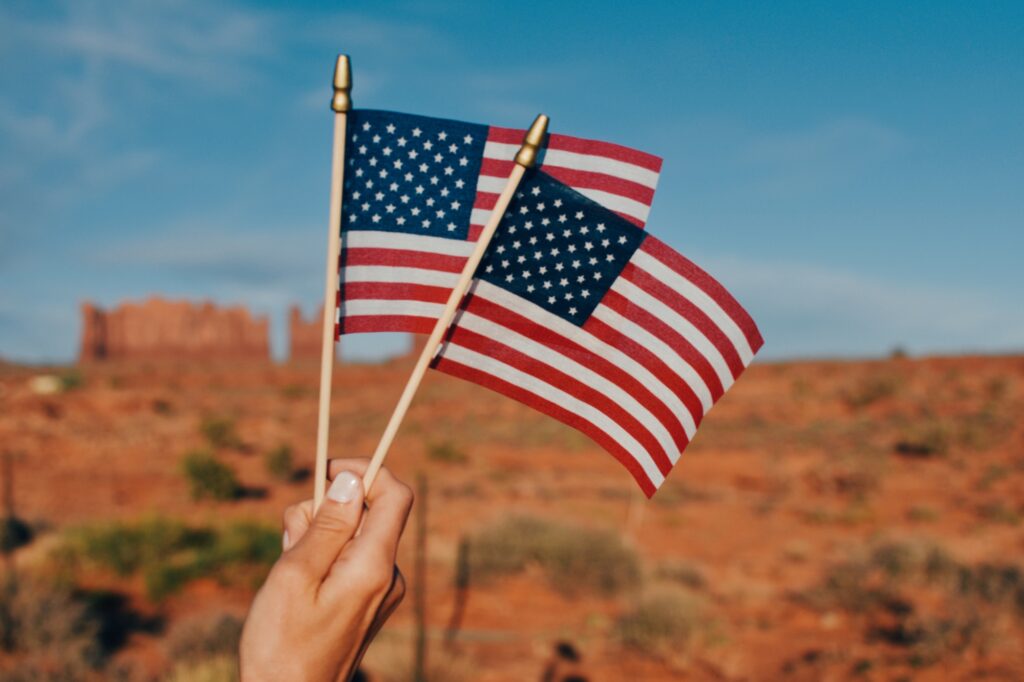 US flags against desert landscape