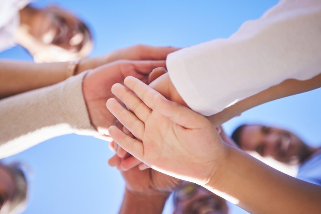 Family, hands together and teamwork below in support for trust, bonding or unity and collaboration